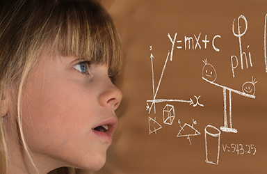 closeup picture of a girl looking at fractions on a brown board