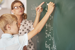 teacher helping boy with math